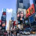 Bustling Times Square in New York with digital billboards and crowds.