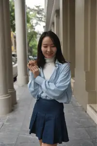 Casual yet fashionable look with a blue pleated skirt and stylish blouse