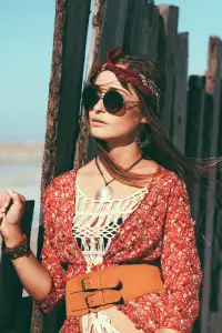 Bohemian style captured with a model wearing a floral dress and vintage accessories