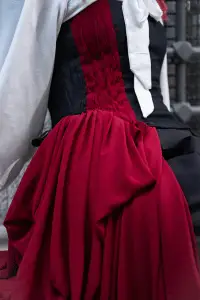 Bold red pleats and structured corset for a sophisticated fashion statement