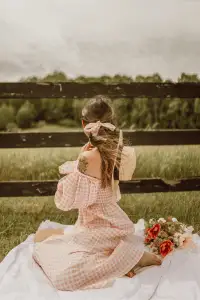 Cottagecore style captured with a model in a soft pink dress and nature-filled backdrop