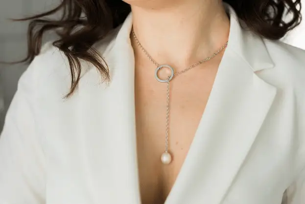 Stylish women’s carter eve necklace featuring a circular clasp and pearl hanging on a chain