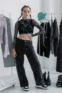 Modern grunge aesthetic with a model in mesh and baggy pants paired with accessories