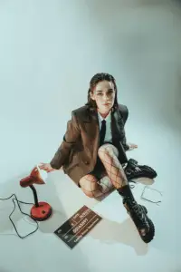 Creative hipster outfit featuring a blazer, fishnet stockings, and trendy footwear