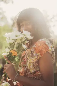 Indie girl with flowers in her hands, radiating natural vibes.