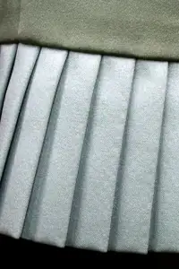 Detailed shot of knife pleats showcasing texture and form