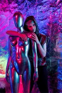 Futuristic woman with metallic mannequin in a neon-drenched cyberpunk world.