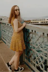 Stylish pleated yellow dress and sneakers on a relaxed day out